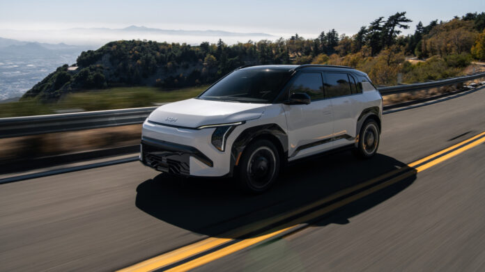 Kia EV3 driving down a coastal highway showcasing its US pricing and design