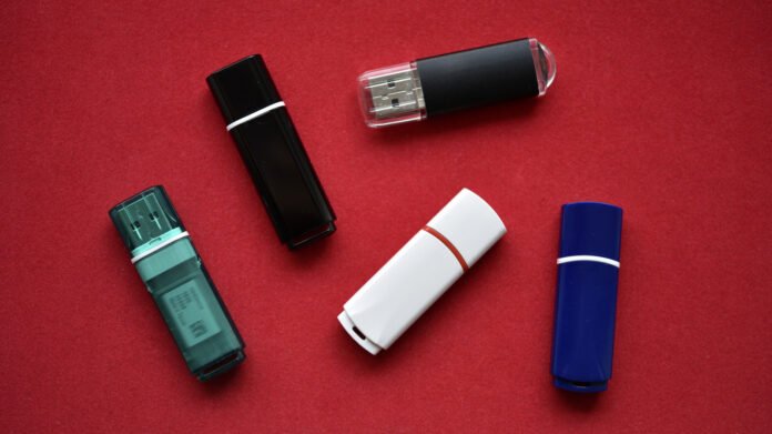 Collection of modern high capacity USB flash drives compared to older small ones