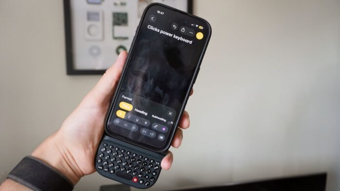 Clicks Power keyboard attached to an iPhone showcasing physical keys and typing experience